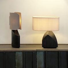 two lamps sitting on top of a wooden table