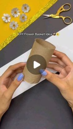 someone is making a flower basket out of toilet paper