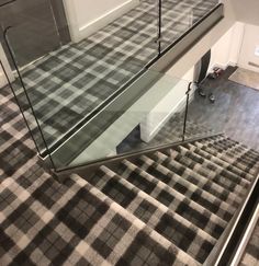 a stair case with glass handrails in a house