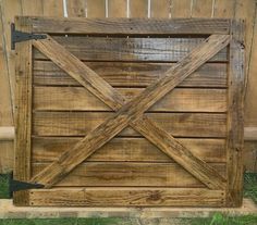 an old wooden gate is being used as a garden divider for the back yard