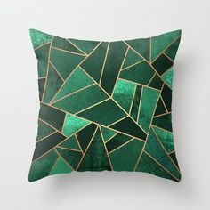 a green pillow with black and white triangles on it