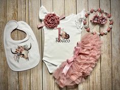 This adorable Baby Girl 1st Rodeo design is on a Flutter Bodysuit and paired with our Dusty Pink Tutu Bloomer and optional accessories. Perfect Western theme outfit with a Boho Western style. Shown on a Flutter Bodysuit, which is soft and stretchy. Family Shirts Available for this set: https://willandtrist.etsy.com/listing/1667187252/matching-family-1st-rodeo-t-shirts-for Personalizations and customizations are welcome! Kindly message me before placing your order for details. You can purchase in Baby Girl Birthday Outfit, Rodeo Birthday Parties, Western Birthday, Rodeo Birthday, Western Babies, Pink Cowgirl, Pink Tutu, Birthday Girl Outfit, Western Theme