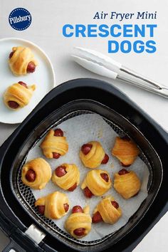 the cover of an air fryer with crescent dogs in it