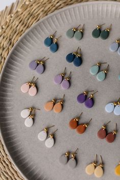 a plate with many different colored earrings on it