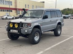 a grey suv parked in a parking lot