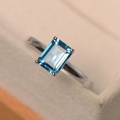 This ring features a 6*8 mm emerald cut Swiss blue topaz,and sterling silver finished with rhodium. Customization is available. It is made by hand, and it will take about 7 days to finish the ring after your payment is completed. Main stone: Swiss blue topaz Main stone weight: Approx 2.01 ct Metal type: sterling silver finished with rhodium Accent stone: none Customization is available, I also can make it with 14k solid gold (white or yellow or rose) and diamond accent stone, just feel free to c Luo Jewelry, Blue Topaz Promise Ring, Emerald Cut Ring, Swiss Blue Topaz Ring, Mystic Topaz Ring, Ring Emerald Cut, Dainty Diamond Necklace, Emerald Cut Rings, Emerald Diamond Ring