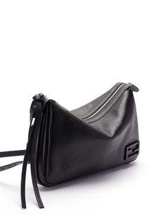 Find FENDI Shoulder Bag on Editorialist. This FENDI shoulder bag is crafted from black calf leather. It features a logo plaque, adjustable shoulder strap, top zip fastening, main compartment, and internal zip-fastening pocket. Fendi Crossbody Bag, Fendi Shoulder Bag, Balenciaga Backpack, Bottega Veneta Shoulder Bag, Strap Tops, Black Bag, Embossed Logo, Fendi Bags, Classic Black