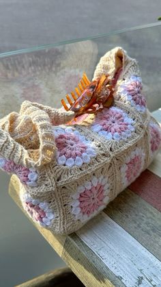 a crocheted purse sitting on top of a wooden table