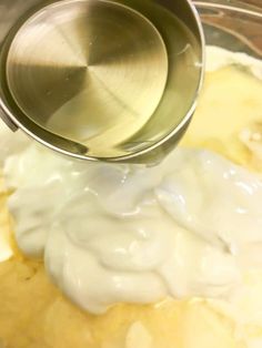 a mixing bowl filled with batter and cream