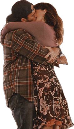 a man and woman hugging each other in front of a white background