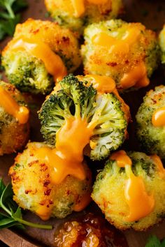 broccoli florets covered in cheese and sauce on a wooden platter