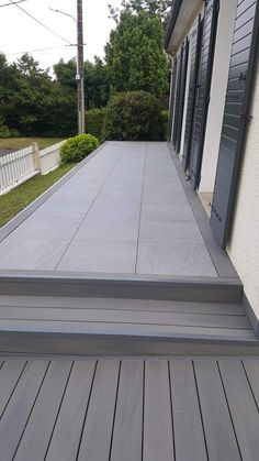 an empty porch with steps leading up to it