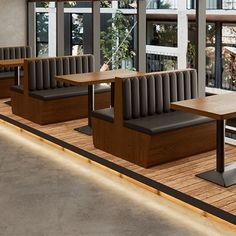 an empty restaurant with wooden benches and tables