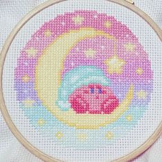 a cross stitch pattern with a pink pig on the moon