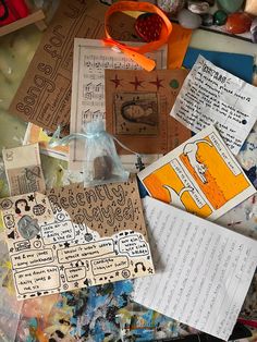 many pieces of paper are on the table with scissors and other crafting items around them