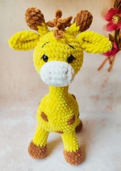 a crocheted giraffe sitting on top of a table