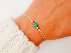 "Choose something unique made just for you. Beautiful bracelet, in the color of your choice, with turquoise gemstone. Side beads and finish is available in two colors, silver or gold. A very cute everyday bracelet, fit on all wrists. Made with color string and macrame slide lock closure. You can wear it alone or layer it with other pieces. Turquoise takes on the characteristics of the owner. This stone is a very personal and meaningful stone to one who wears it. Turquoise is a master healing sto Minimalist Turquoise Bracelets For Beach, Minimalist Turquoise Bracelet For Friendship, Adjustable Minimalist Turquoise Jewelry, Handmade Minimalist Turquoise Bracelets, Minimalist Turquoise Bracelet For Gift, Meaningful Stone, Bracelet Bff, Bff Gift, Everyday Bracelet