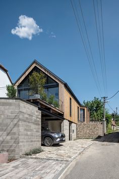 a car is parked in front of a house that has been built into the side of it