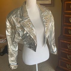 Like New, Cropped Silver Leather, Crystal And Gold Studded Jacket. All Studs Intact. Interior Lining Pristine, Seems Unworn. Looks Like A Jacket Dolly Parton Would Wear! Shoulder Pads, Country Glam Style. Details At Cuffs. Was Custom Made As One Of Three For The Del Rubio Triplets Of Pee Wee Playhouse Fame! Whip It! I Have A Gold One Same Style/Triplets For Sale As Well. Truly Unique And Fabulous. Cool For Burning Man Too Tbh, The Shine! Halloween Disco Country Leather Jacket Unique, Silver Glamorous Formal Outerwear, Silver Fitted Outerwear For Evening, Glamorous Silver Formal Outerwear, Metallic Leather Jacket For Fall Party, Silver Fitted Outerwear For Spring, Silver Long Sleeve Leather Jacket For Fall, Silver Leather Long Sleeve Jacket For Fall, Metallic Fitted Evening Outerwear