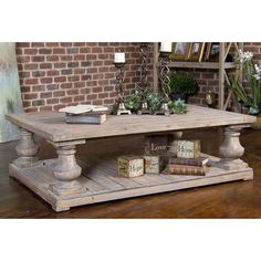 an old wooden coffee table with books on it