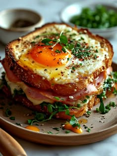 an egg and ham sandwich on toast with parsley sprinkled around the edges