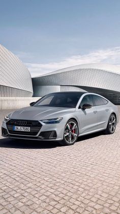 a silver car parked in front of a building