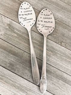 two spoons with words on them sitting next to each other