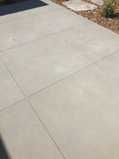 a skateboard is sitting on the concrete in front of a house