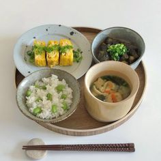 a tray with rice, meat and vegetables on it