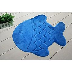 a blue fish rug is on the floor in front of a potted plant,