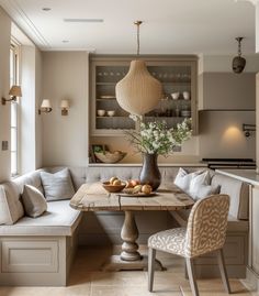 a table with some fruit on it in the middle of a living room filled with furniture