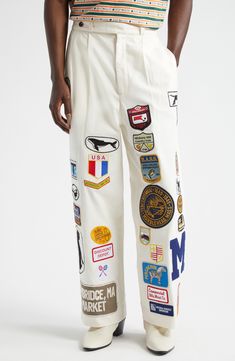 Classic workwear from the '40s and '50s serves as the model for these cotton-canvas pants detailed all over with vintage and reproduction-vintage patches. 29" inseam; 22" leg opening; 15" front rise; 17 1/2" back rise (size 34) Zip fly with button-tab closure Side-seam pockets; back welt pockets 100% cotton Dry clean Imported Designer Clothing Patches Aesthetic Clothes, Kapitol Clothing, Bode Pants, Pants With Patches, Unisex Clothing Fashion, Patch Clothes, Denim Diy Clothes, Patches On Clothes, Patched Denim