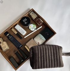 an open wooden box containing cosmetics and personal care items