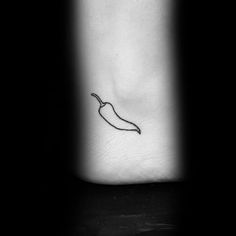 a black and white photo of a chili pepper on the ankle