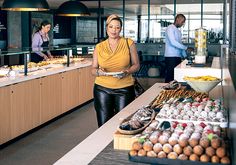 a woman standing in front of a buffet filled with food