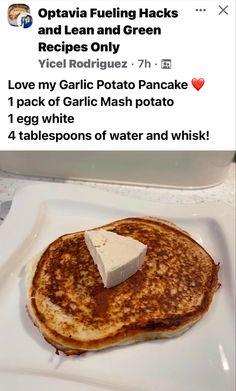 a white plate topped with pancakes covered in butter