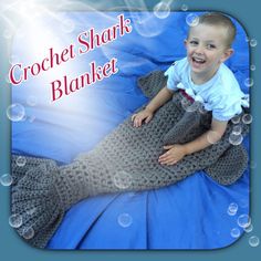 a little boy that is laying down on a mermaid tail with bubbles around him and the caption crochet sharks blanket