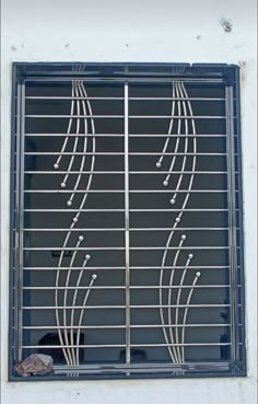 an image of a window that has bars on it and lines painted on the side