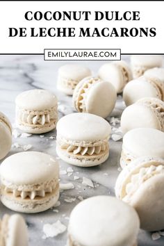 macarons are arranged on a marble surface with the words coconut dulcee de leche macarons