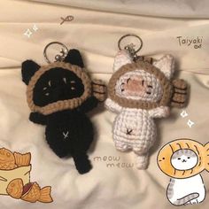 two crocheted keychains are sitting on a bed with cartoon characters around them