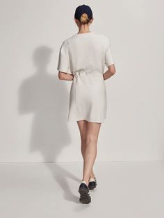 Crew neck t-shirt style dress This Above-the-knee piece features a waist cinch with toggles, side pockets, and seam detailing Maple Dress, Tiered Midi Skirt, Boys Swimwear, Shirt Dress Style, T Shirt Style, Long Crop Top, Summer Staples, Casual Coat, Ladies Boutique