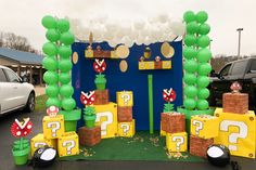 a nintendo themed birthday party set up with balloons and paper cutouts on the ground