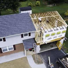 an overhead view of a house under construction with the roof being framed up by scaffolding