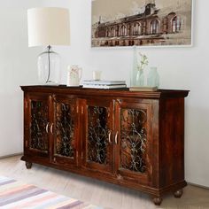 a large wooden cabinet sitting in the corner of a living room next to a lamp