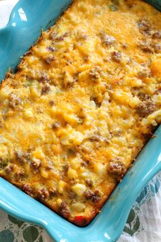 a blue casserole dish with meat and cheese