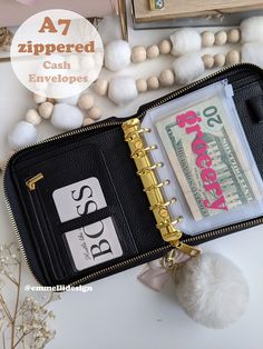 an open wallet sitting on top of a table next to some beads and other items