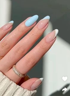 a woman's hand with blue and white nails