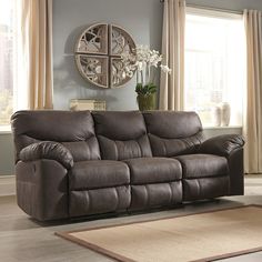 a living room scene with focus on the reclining sofa