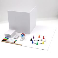 an assortment of items are displayed on a white surface with pencils, markers and erasers