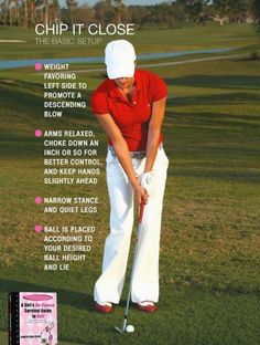 a woman in white pants and red shirt playing golf